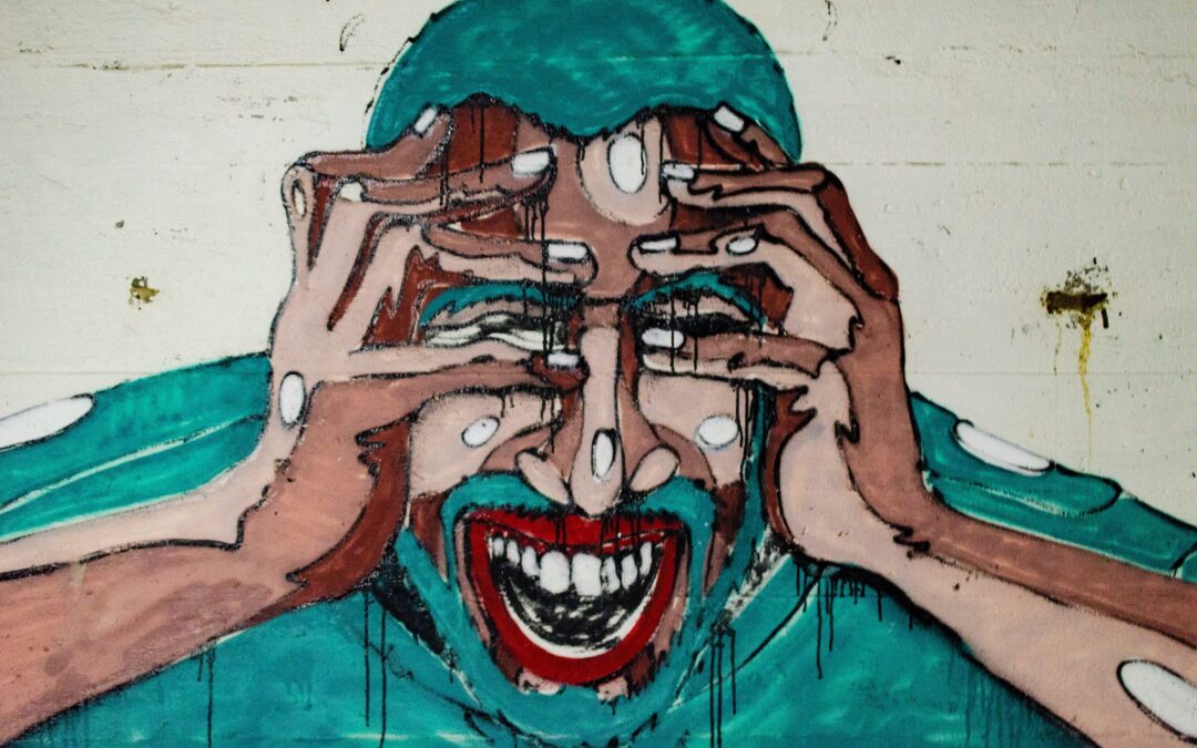 A artwork on a wall of a man in blue holding his head while he screams