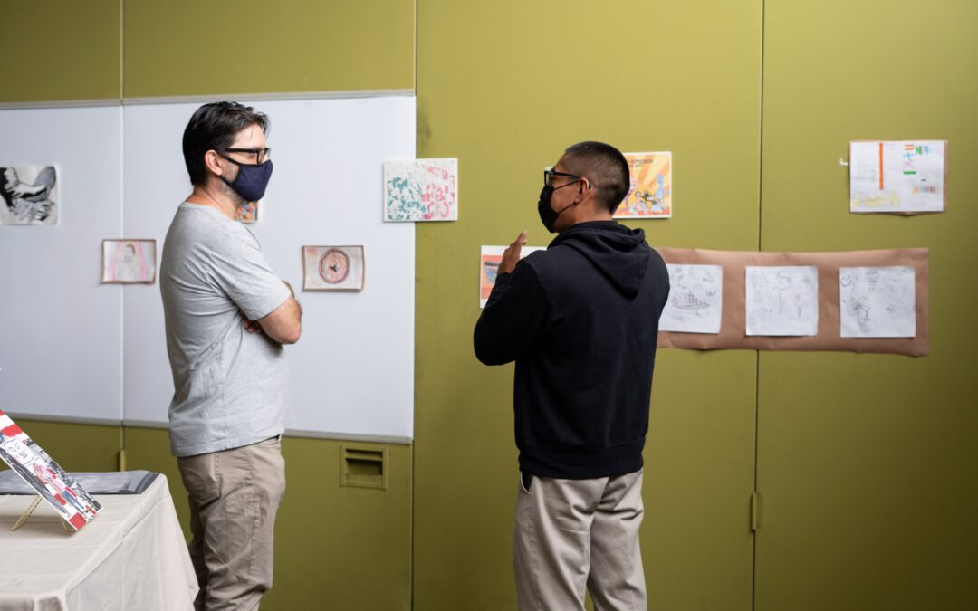 People discussing art at the Saito High School Art Exhibit