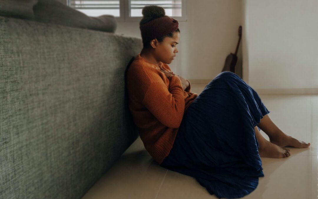 Person is sitting on the floor while experiencing anxiety