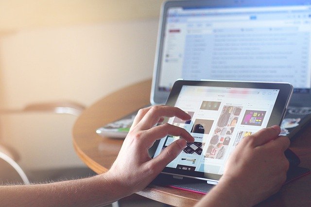 Digital Media and Mental Health- a person holding a tablet looking at the screen