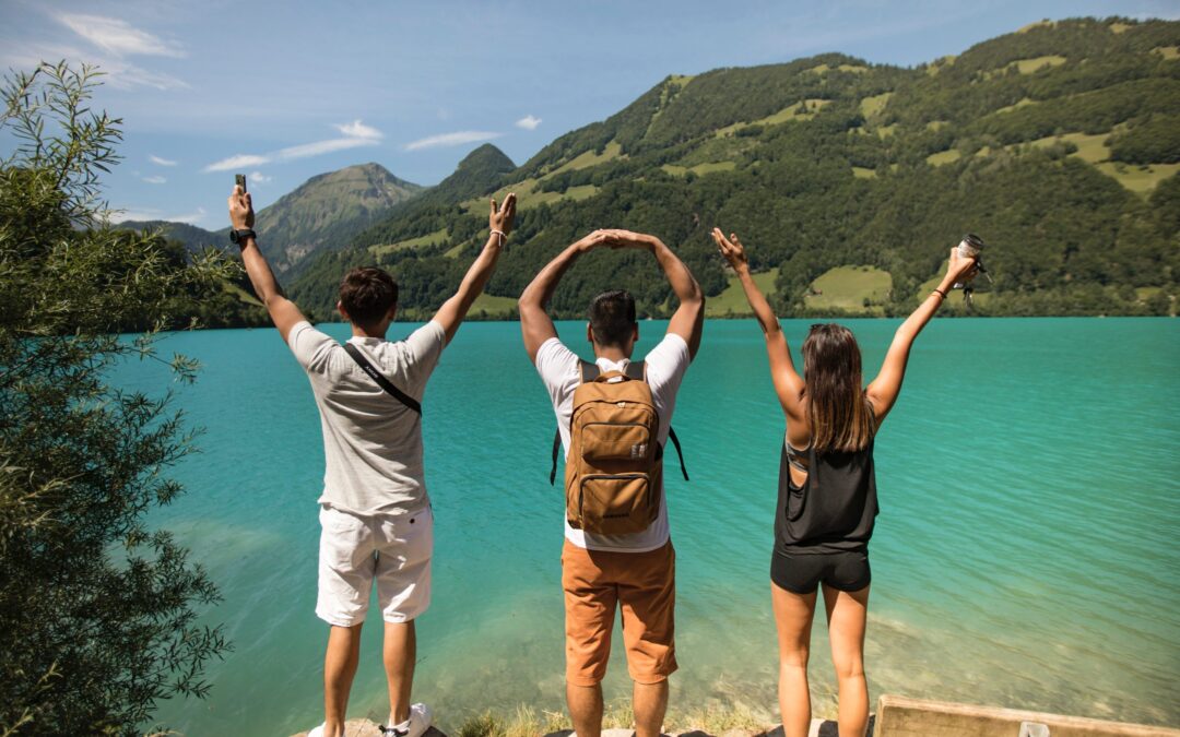 Three tourists facing a lake on a bright summer day stephen-leonardi-knhr826qIMA-unsplash