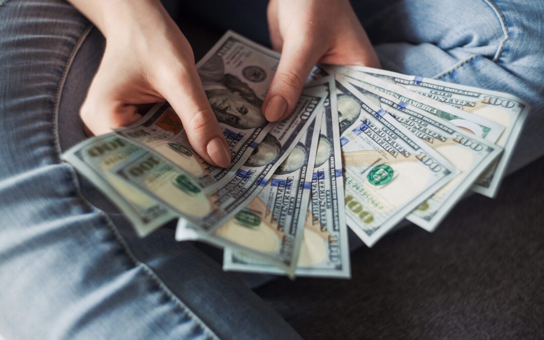 Person Holding 100 Us Dollar Banknotes