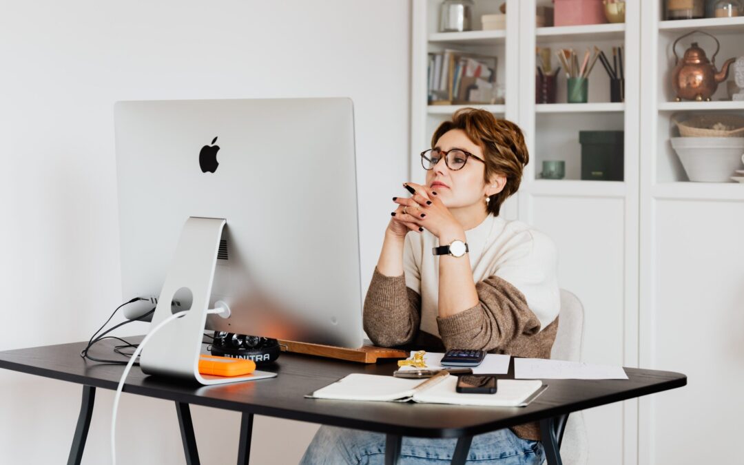 Focused female employee reading information on computer in office