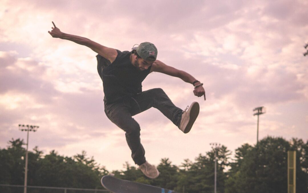 a person on a skateboard is in the air and the skateboard is spinning under him.