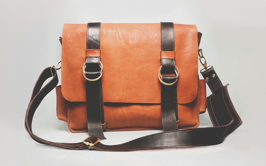 a leather handbag with dual leather straps, everything is made of leather and the skin is a nice orange tan while the straps are a nice dark leather.