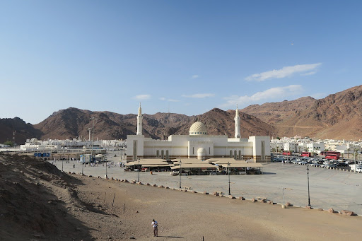 a white mosque in a desert setting