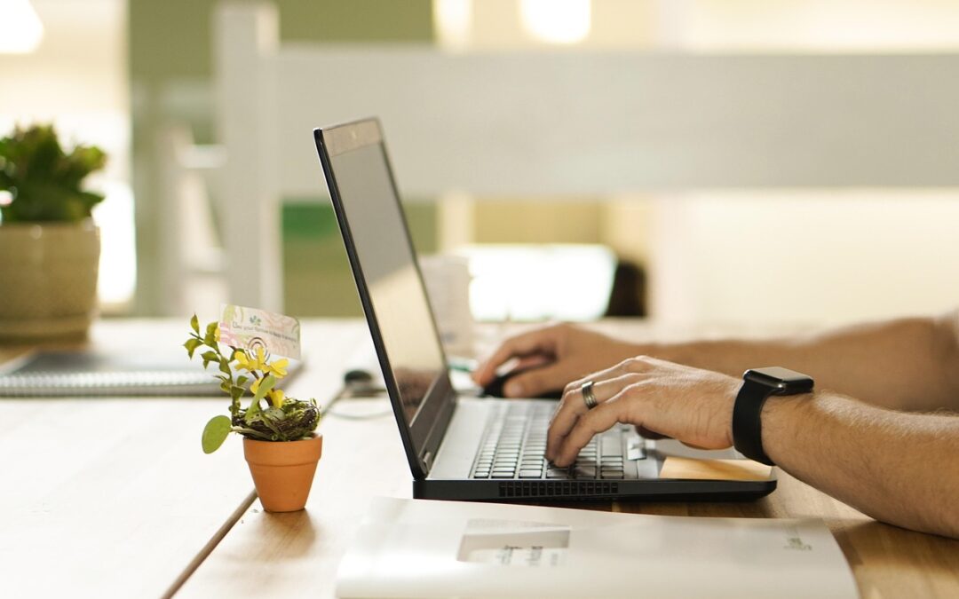 a person working on a laptop in an office setting - Mental health online