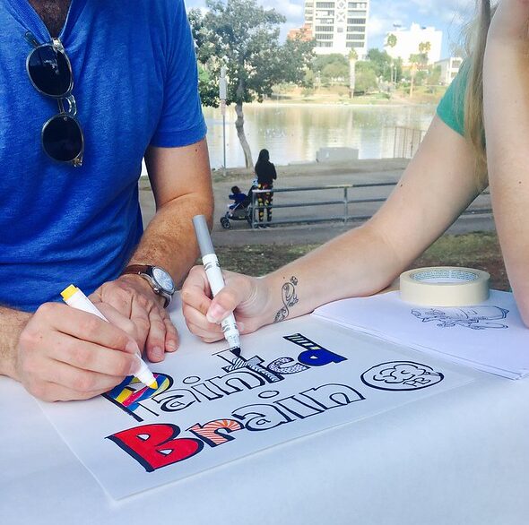 Two-artists-participating-at-Painted-Brains-Art-Cart-at-MacArthur-Park-in-Los-Angeles